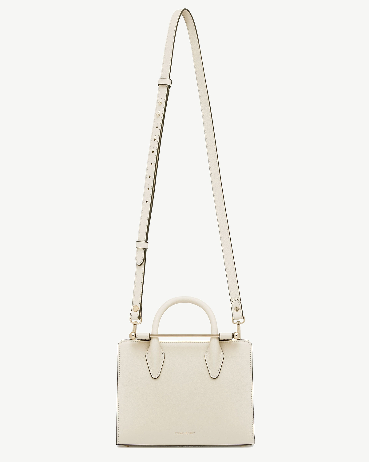 Vanilla leather handbag with top handle and thin adjustable shoulder strap, Strathberry logo.