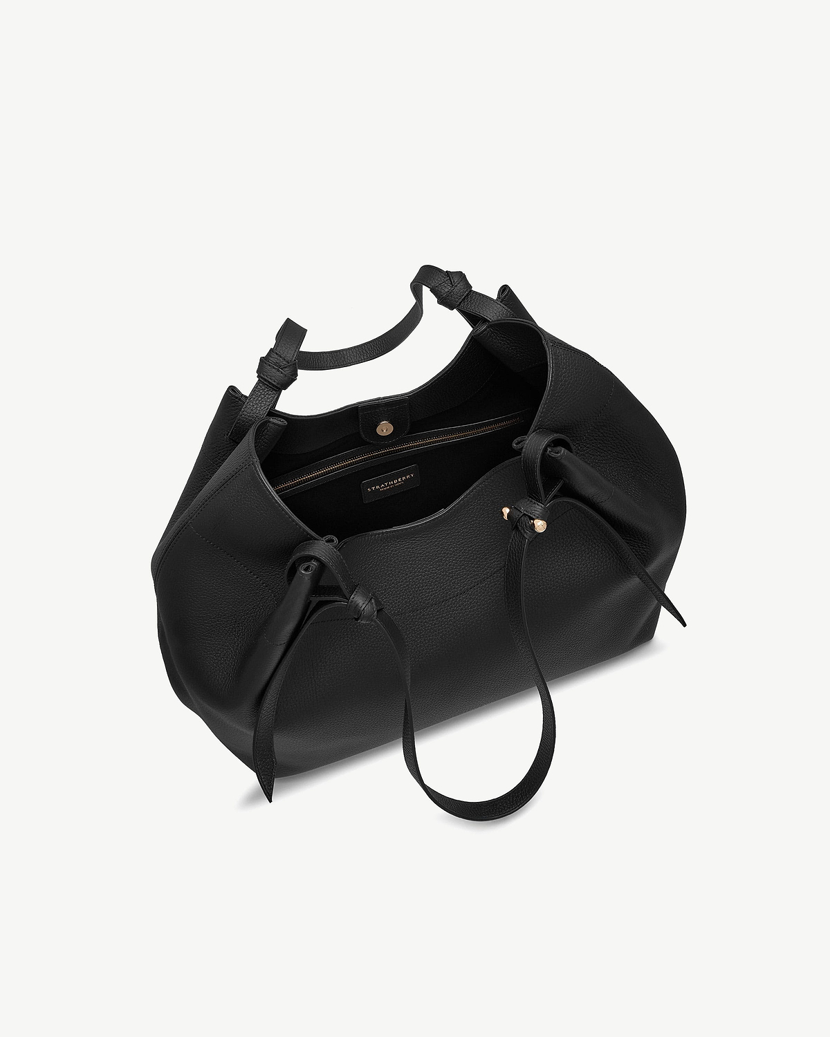 Black Strathberry Barra tote with open top, zip pocket, drawstring and gold studs.