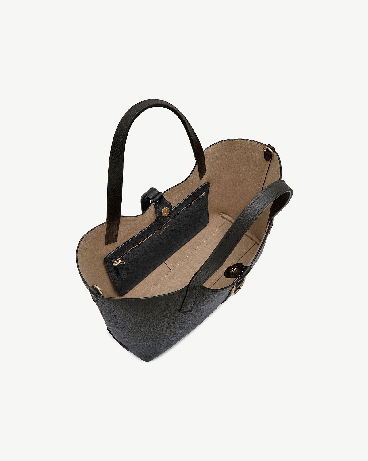 Black leather tote with two handles, beige interior, open top and zip pocket.