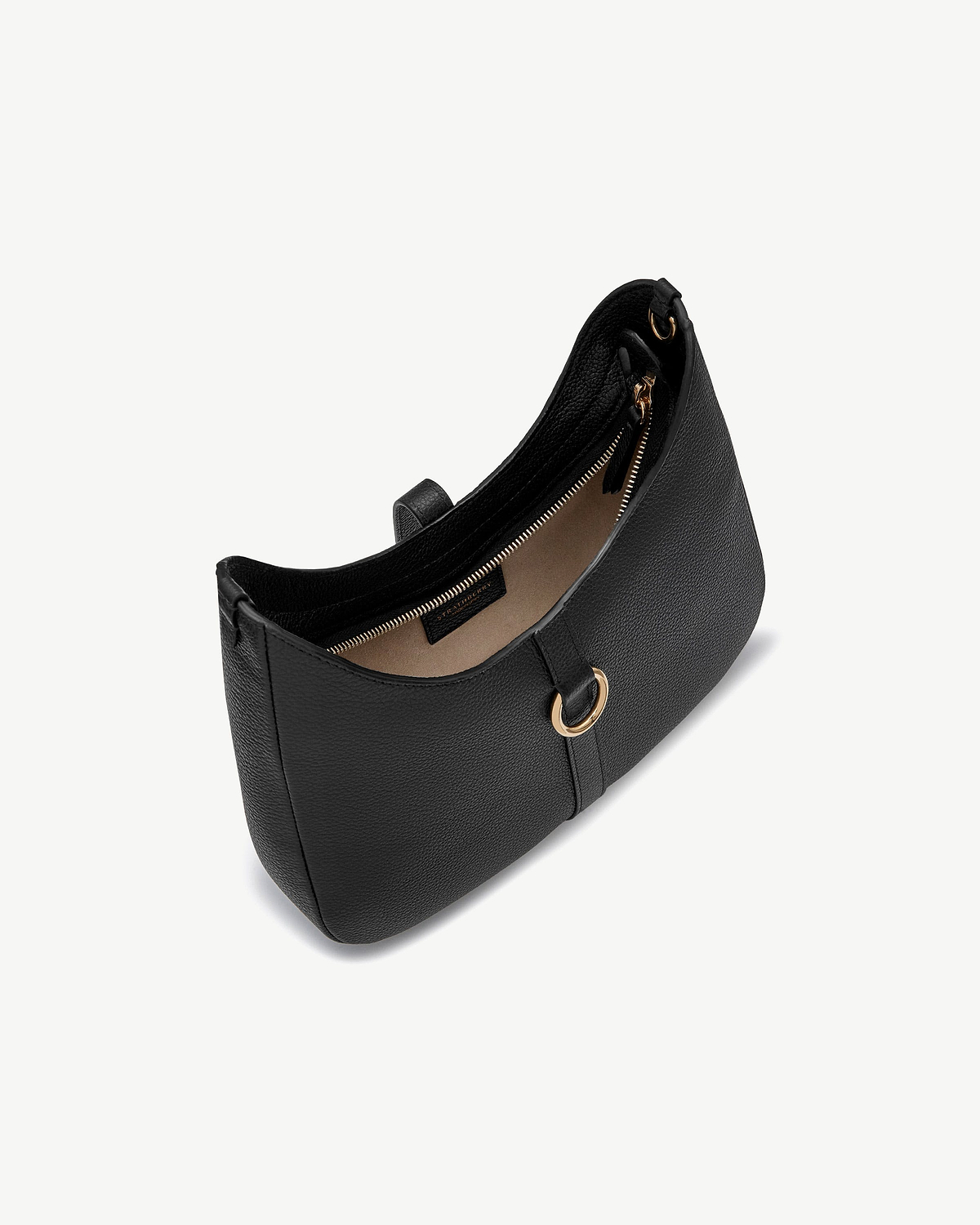 Black Kite Sling bag against white background, pebbled leather with gold ring detail.