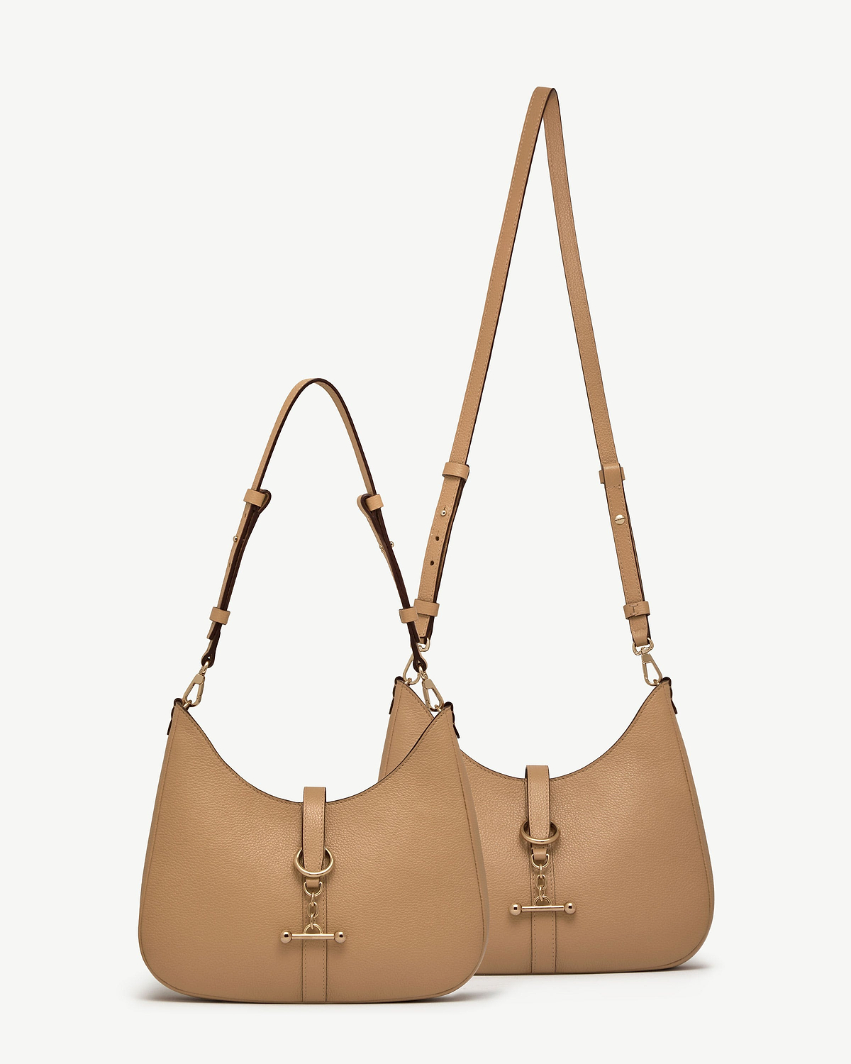 Two caramel kite sling bags with adjustable straps and gold-tone hardware.