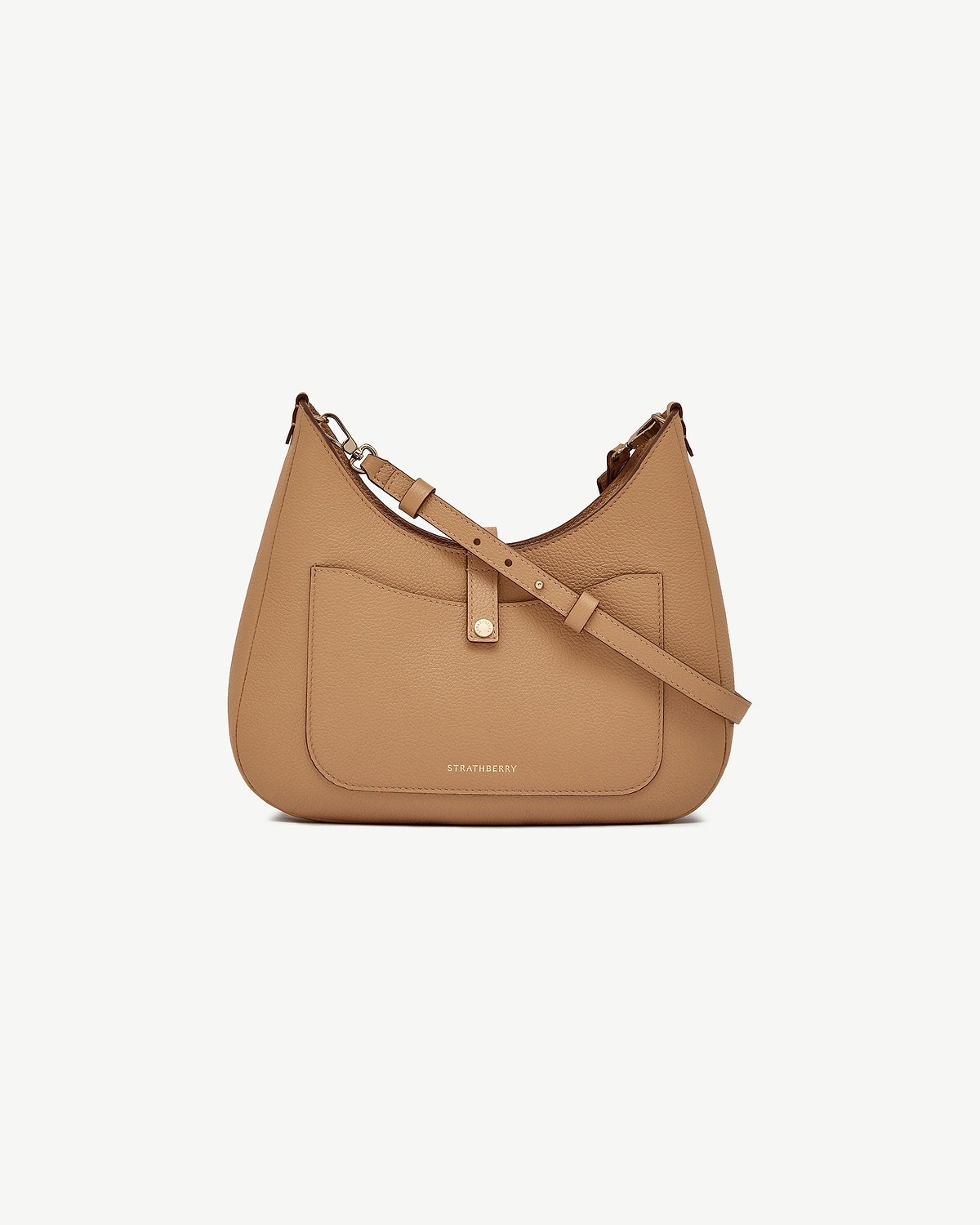 Caramel Strathberry kite sling bag with front pocket and adjustable shoulder strap.