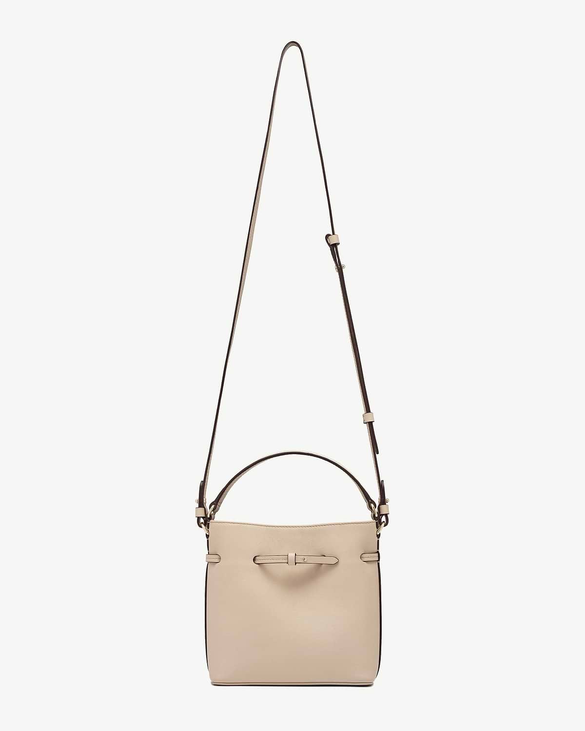 Oat-coloured mini bucket bag with adjustable shoulder strap and small top handle