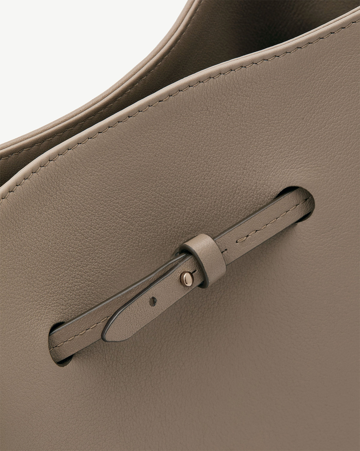 Taupe Corda bucket bag leather showing stitching and strap detail.