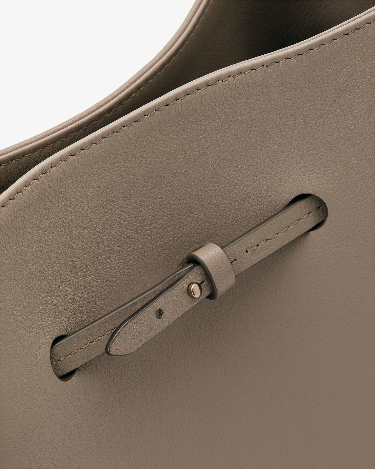 Taupe Corda bucket bag leather showing stitching and strap detail.