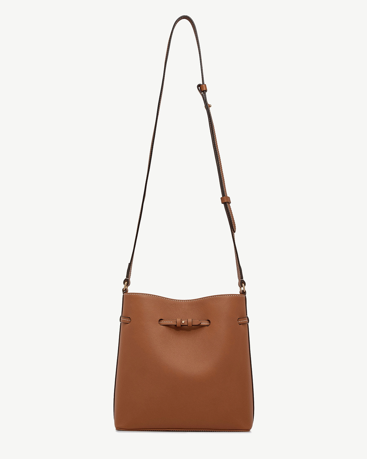 Chestnut leather bucket bag with long adjustable strap and knotted front detail.