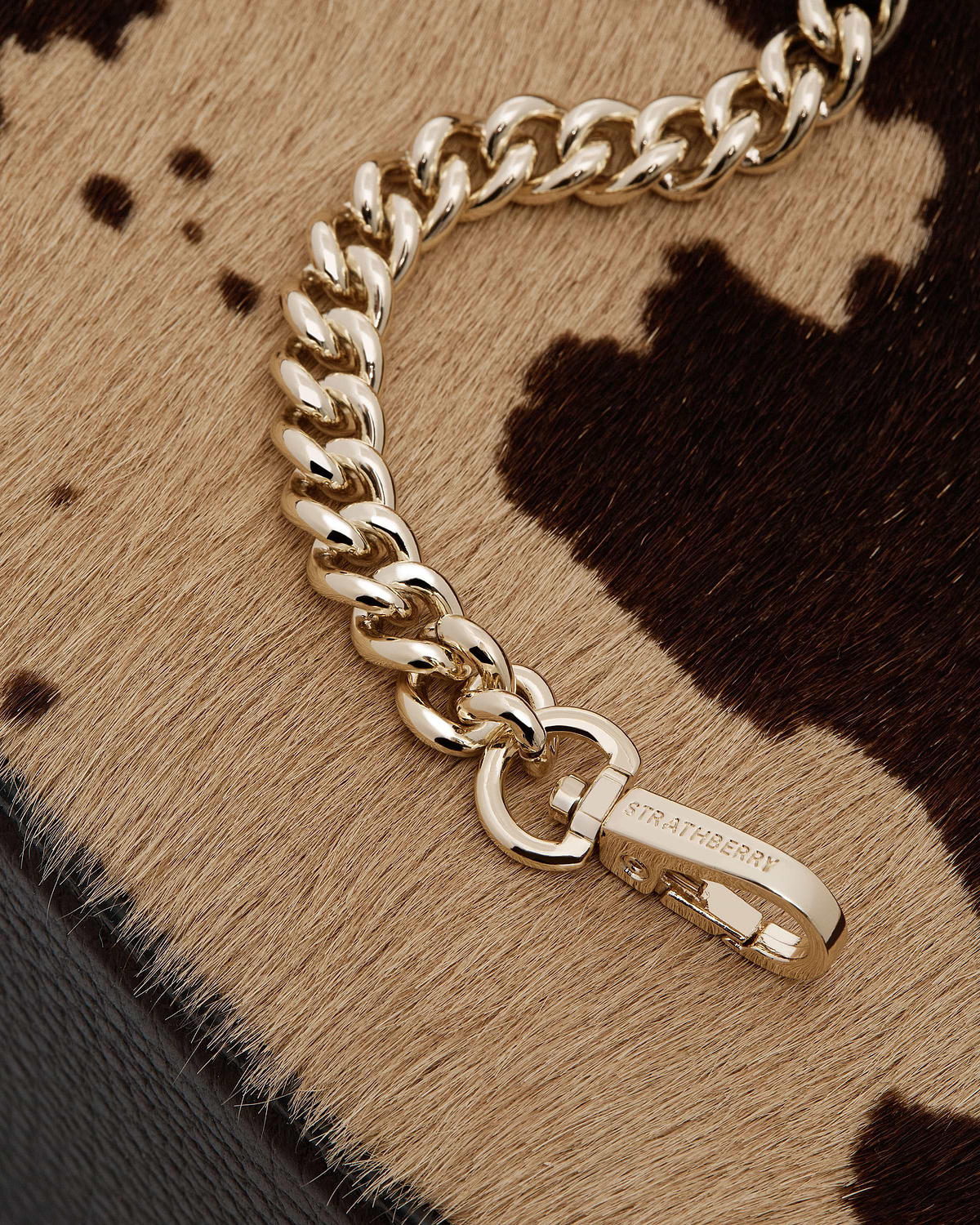 Gold chain and Strathberry clasp on sand and espresso spot calf hair