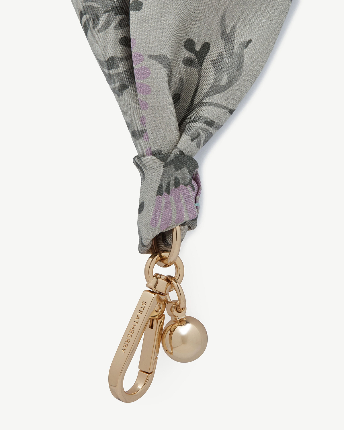 Silk charm in green thistle print tied to a gold Strathberry keyring with charms