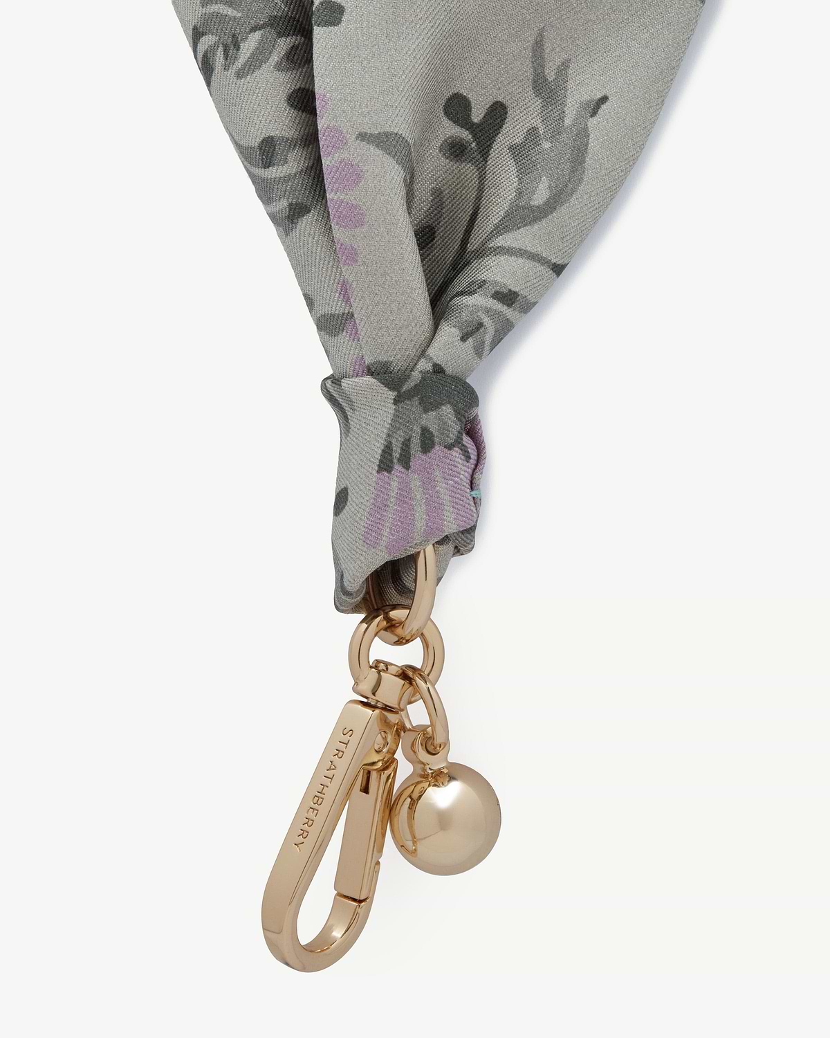 Silk charm in green thistle print tied to a gold Strathberry keyring with charms