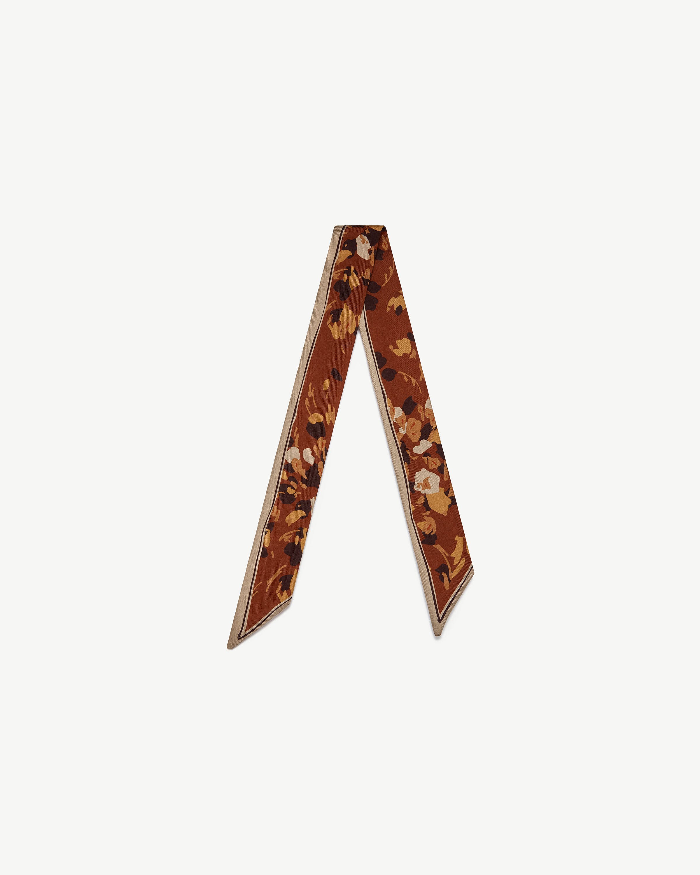 Silk skinny scarf in sand and oxblood with pop flower print, arranged in V shape.