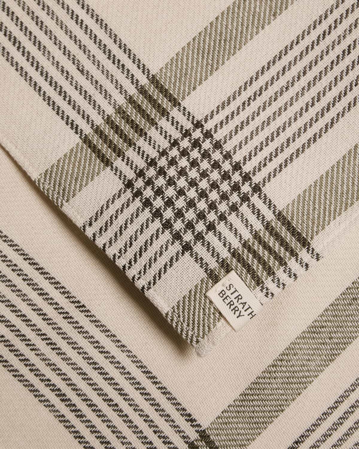 Beige and olive tartan cotton-linen table runner with Strathberry label.