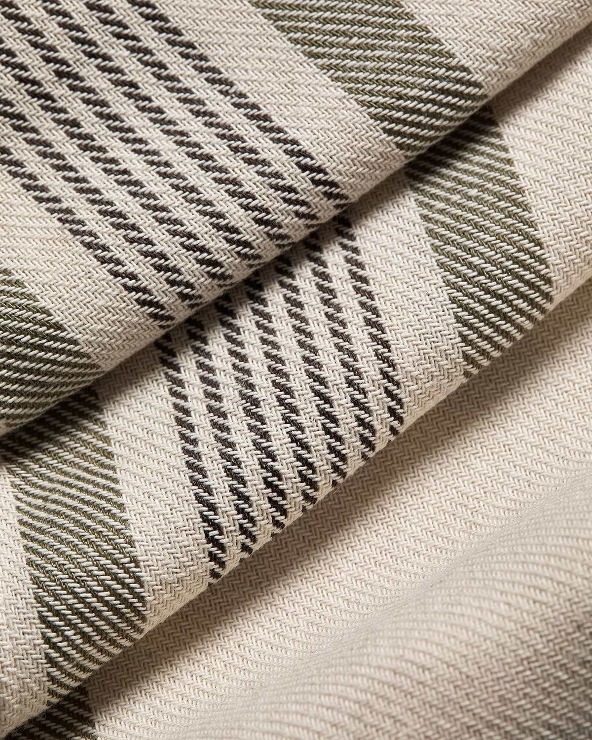 Woven cotton-linen table runner with green and brown tartan stripes.