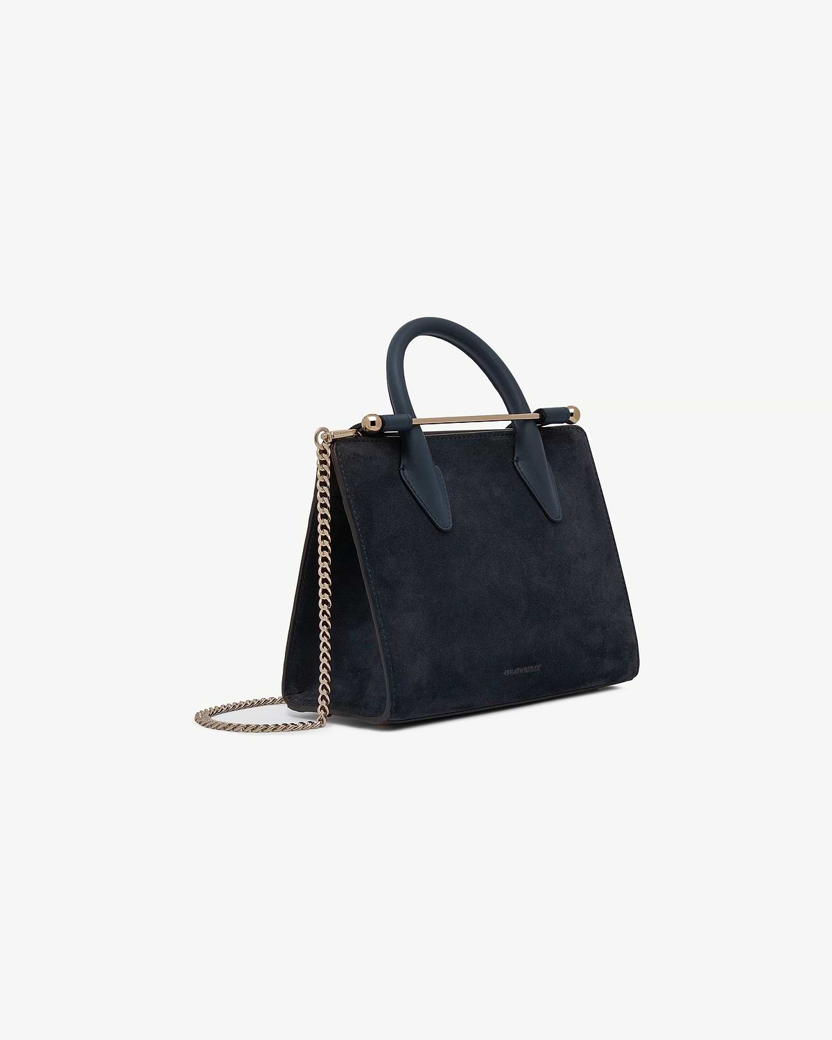 Strathberry navy suede mini tote with top handles, gold bar and chain strap.