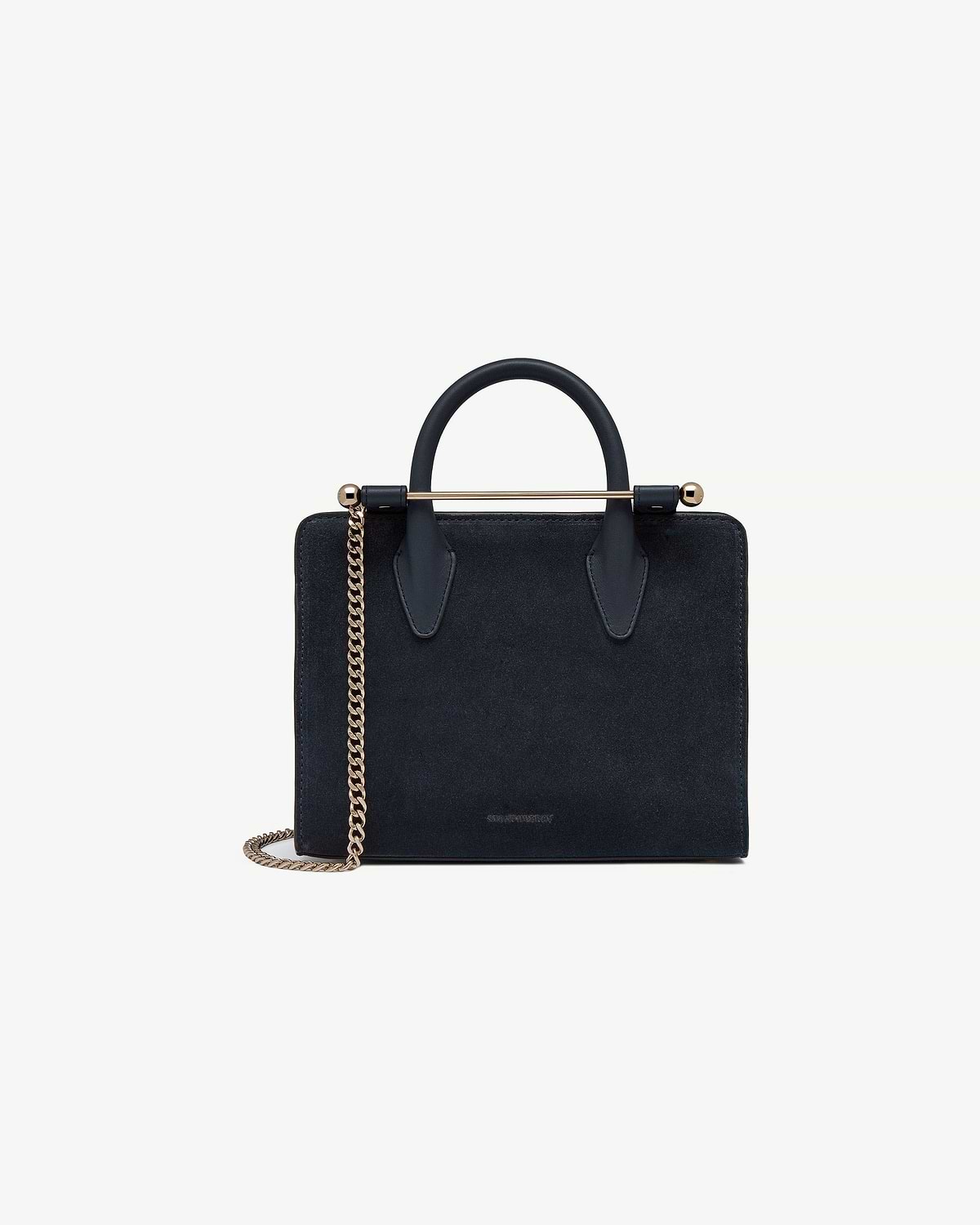 Navy suede mini tote with top handle, gold bar detail and chain strap.