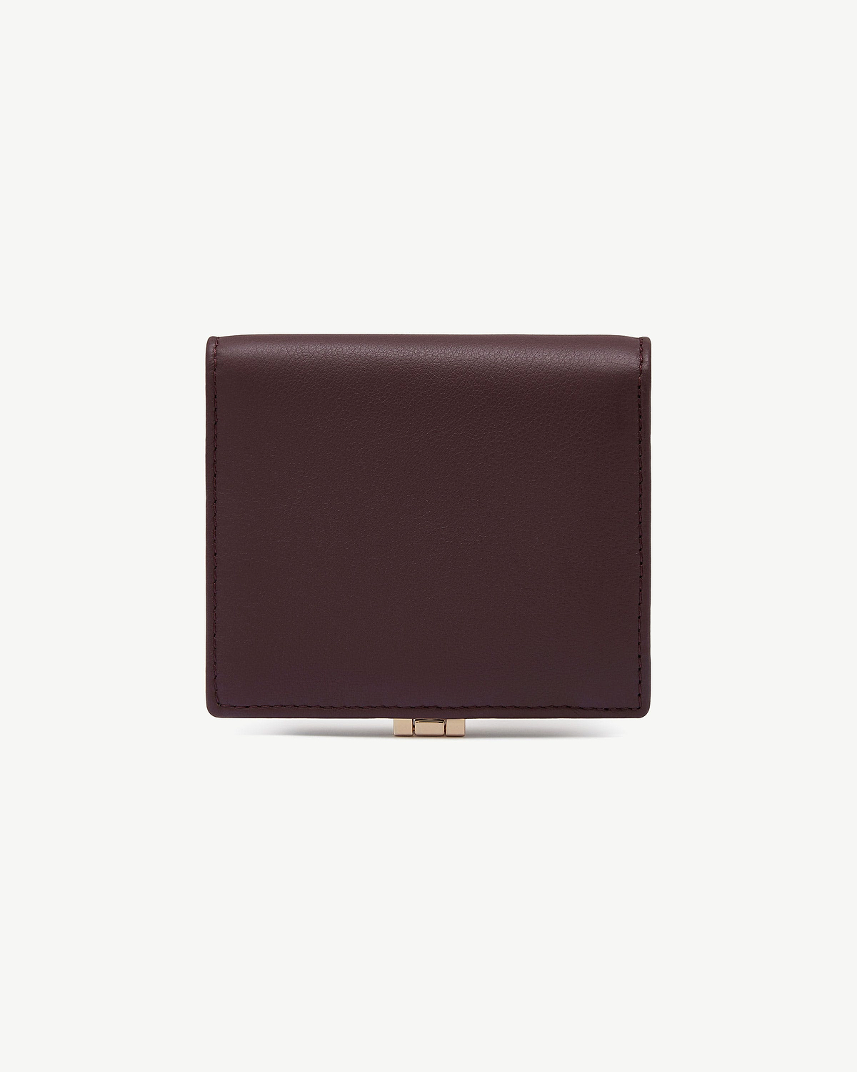 Top section of burgundy and walnut leather wallet with gold clasp.