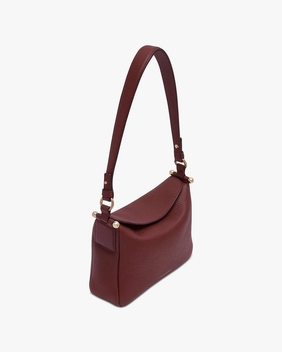 Oxblood pebbled leather shoulder bag with flap and gold hardware.