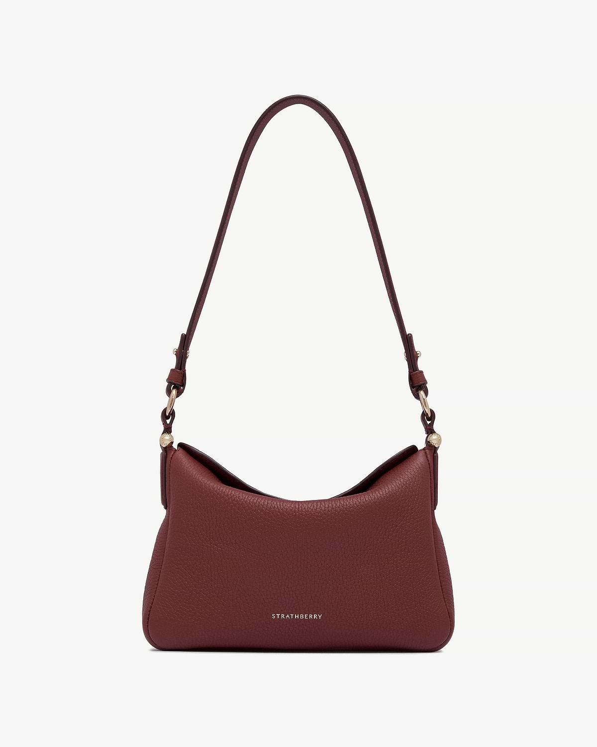 Strathberry Sway oxblood leather shoulder bag with long strap and gold hardware.
