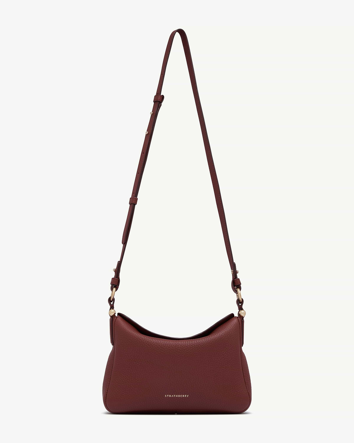 Strathberry Sway oxblood leather shoulder bag with adjustable strap and gold hardware.
