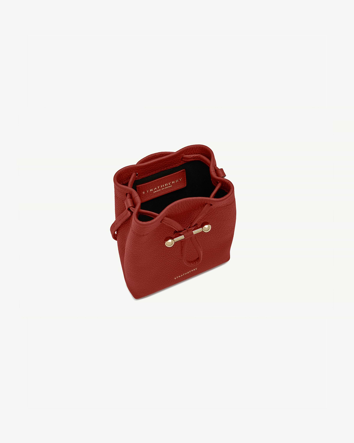 Strathberry Osette midi pouch in Levanto red with drawstring and gold bar.