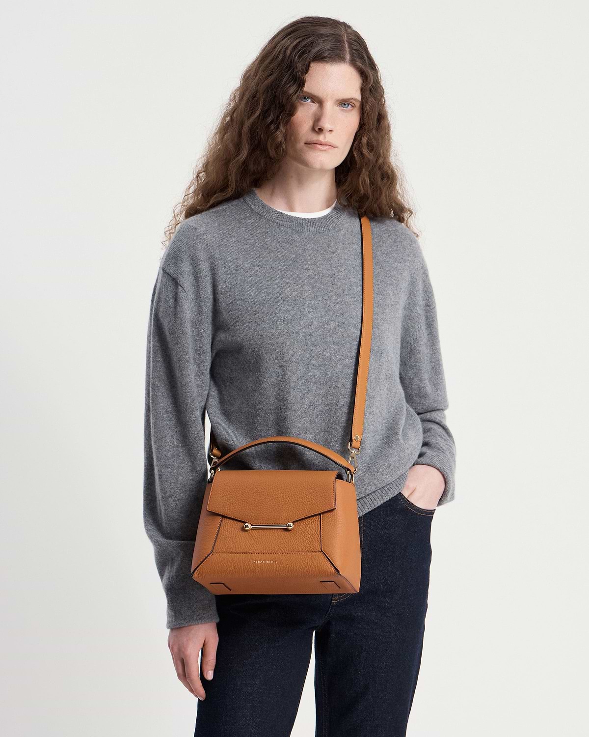 Model wearing grey sweater with honey mosaic bag, top handle and shoulder strap.