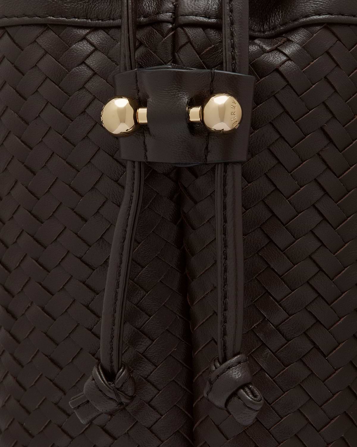 Woven chocolate leather drawstring with knotted ends and gold studs
