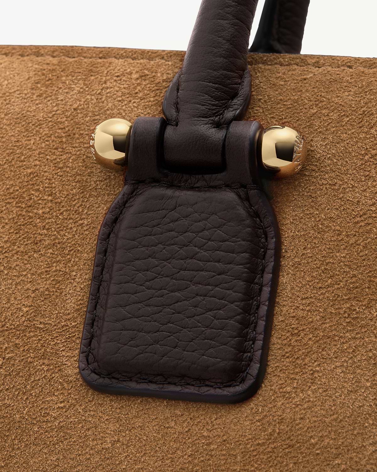 Espresso leather strap with gold ball hardware on toffee suede background