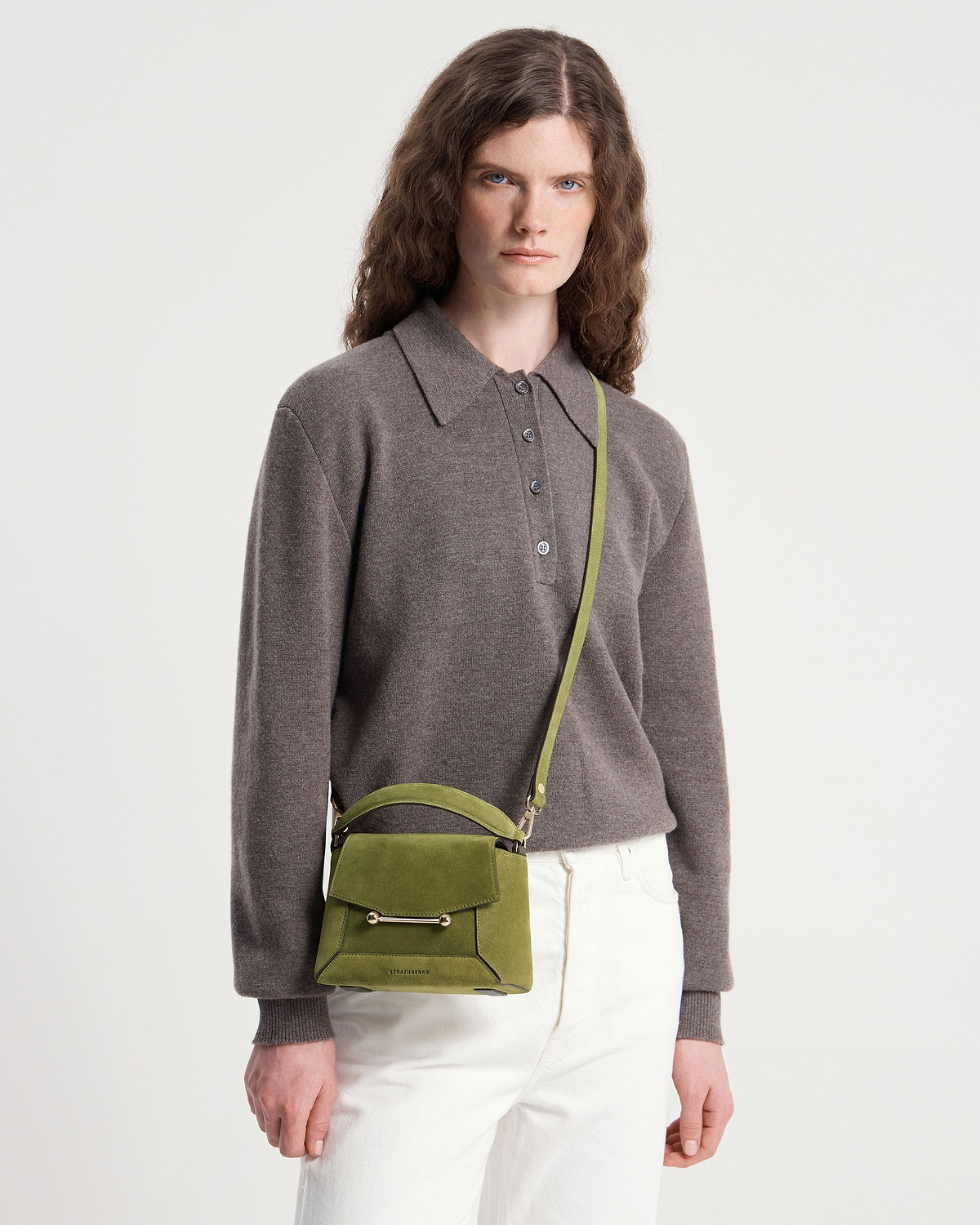 Model wearing Strathberry Mosaic Nano bag in lime suede, crossbody strap visible.