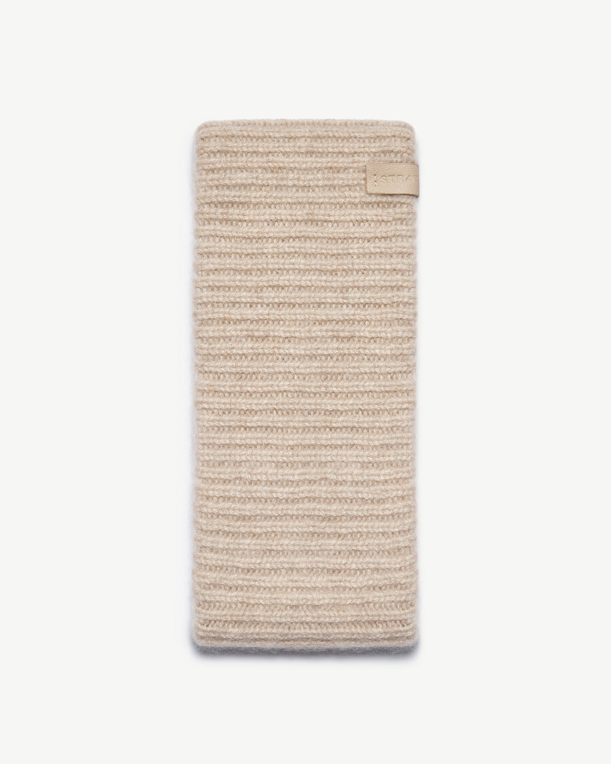 Ribbed cashmere headband in oat, rectangular knit with small leather tab.