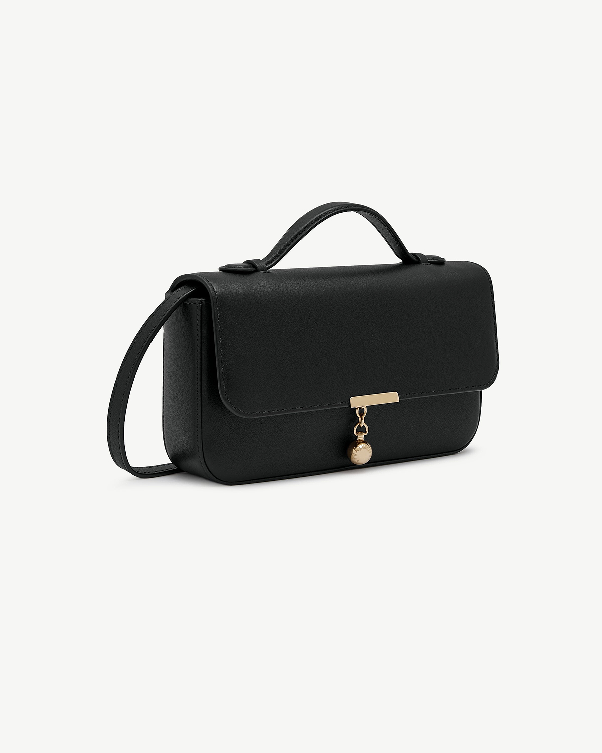 Black clutch with top handle, shoulder strap and gold charm.
