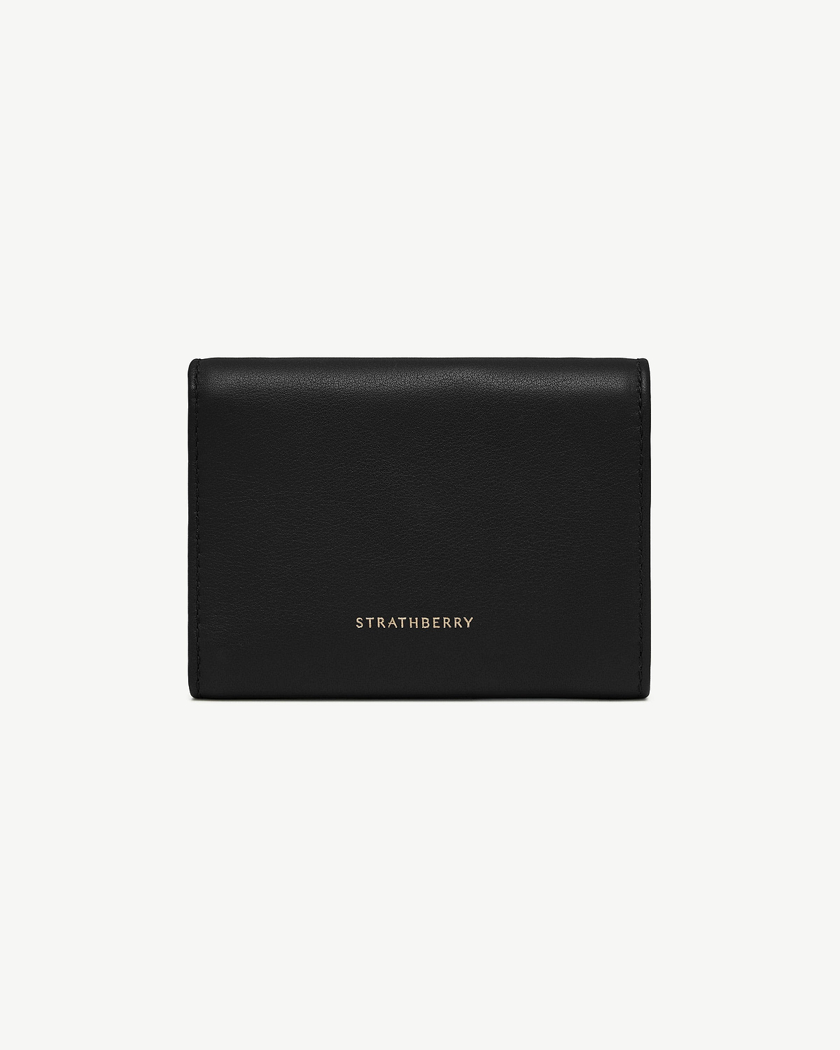 Black trifold leather wallet with Strathberry gold logo, vertical view.