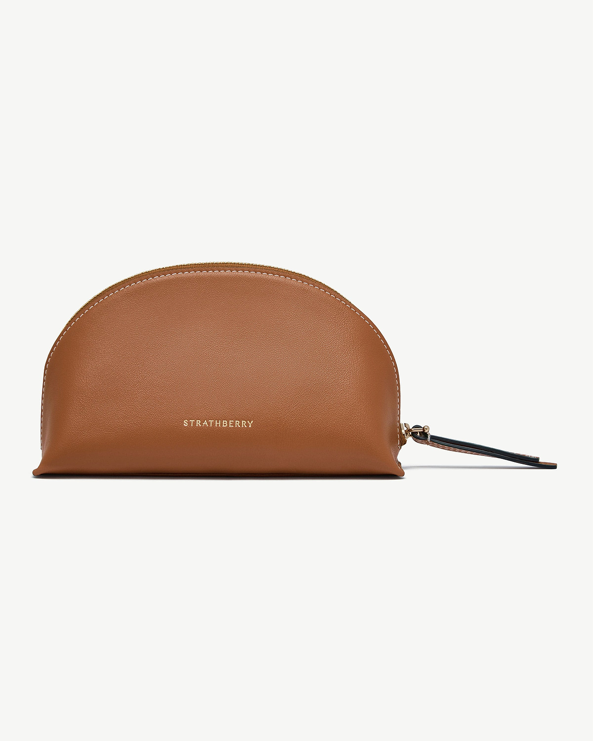 Tan leather Strathberry Nest pouch with gold logo and wrist strap.
