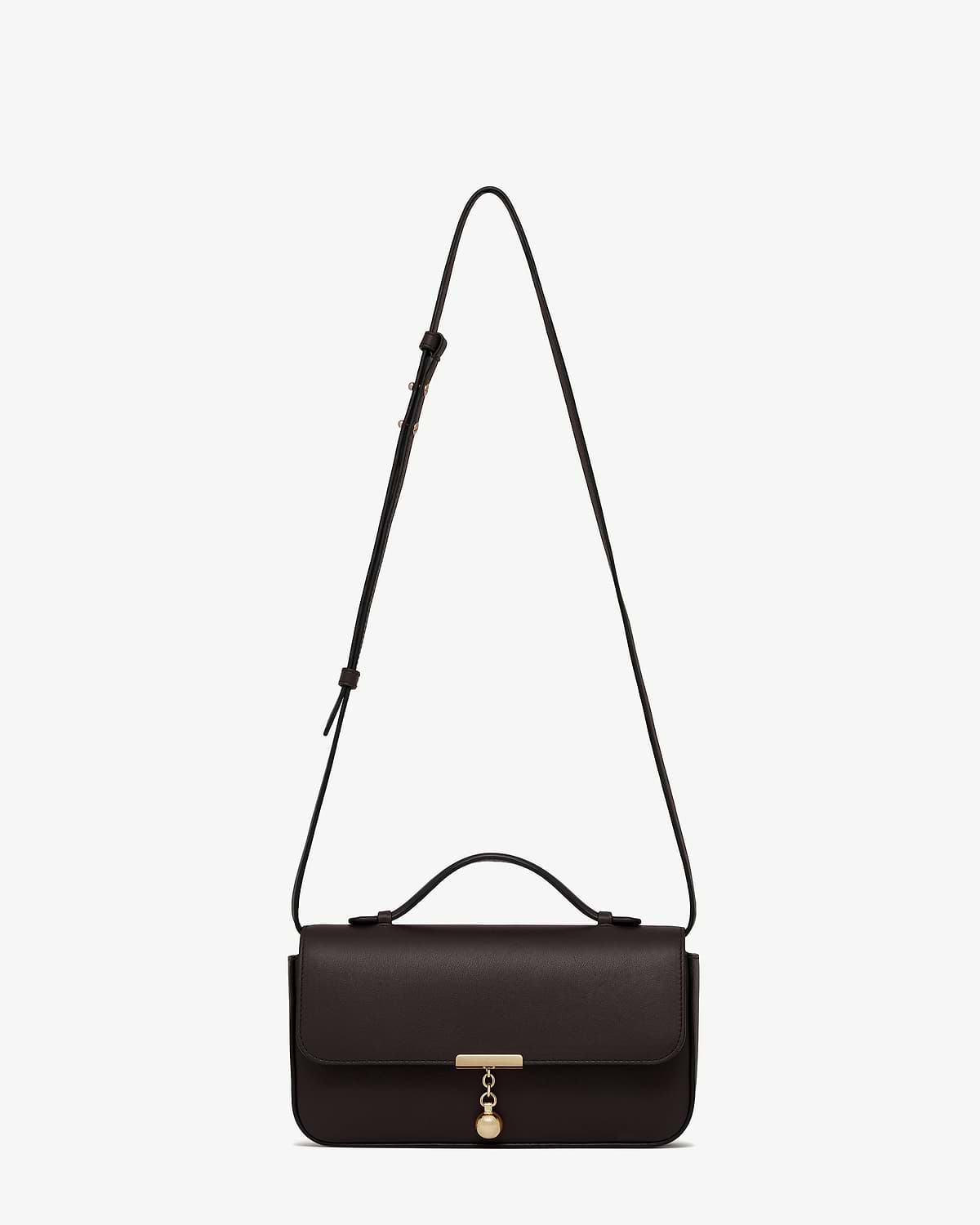 Espresso leather Nocturn clutch with top handle, adjustable shoulder strap and gold charm.