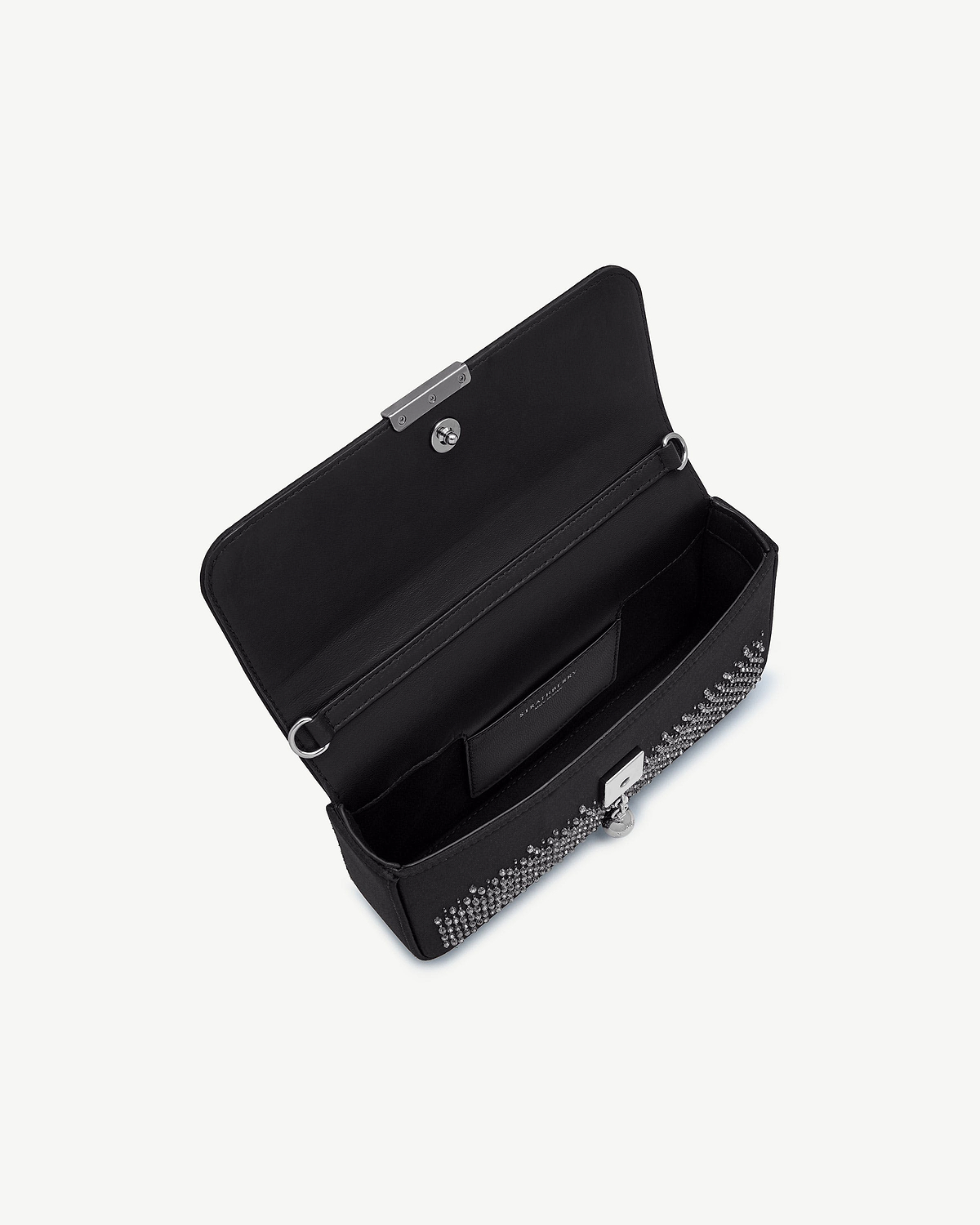 Open black embroidered satin clutch showing interior, strap rings and crystal embellishments.