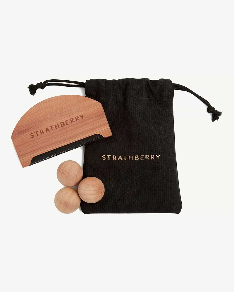 Black Strathberry drawstring bag with wooden brush and three wooden balls