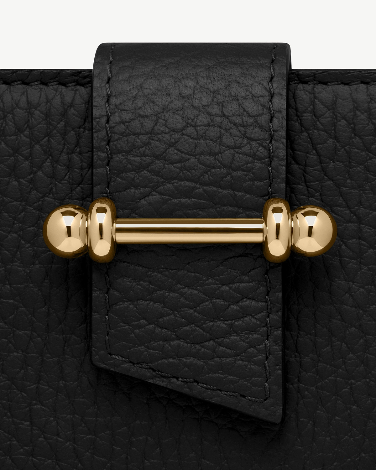 Black grained leather strap with visible stitching and gold bar hardware detail.