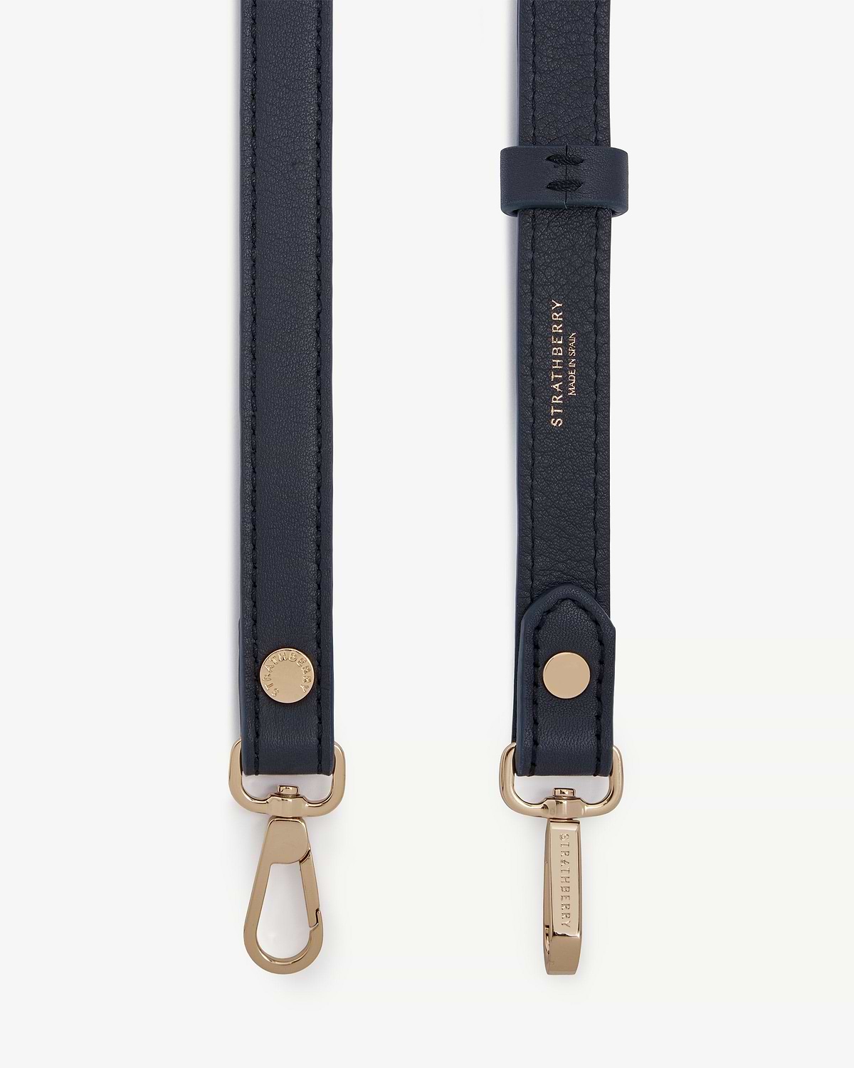 Marine blue thin adjustable leather strap with gold hardware and Strathberry logo.