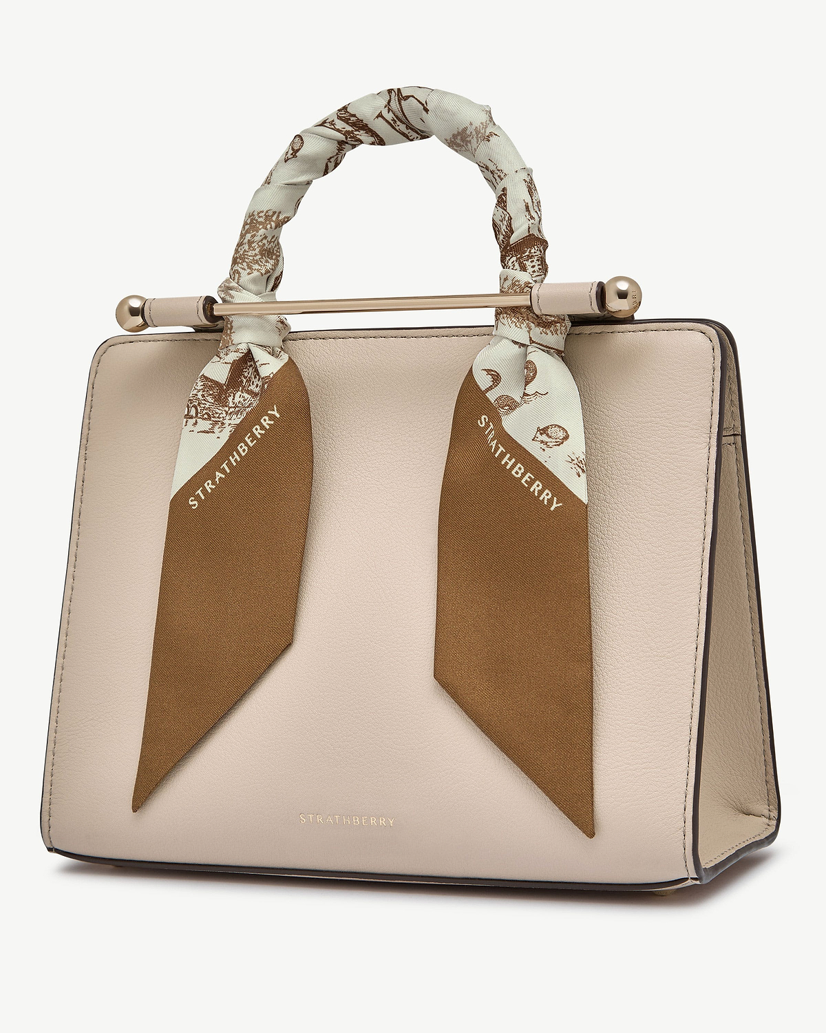 Silk skinny scarf in tan and vanilla animal print tied around beige handbag handle, Strathberry.