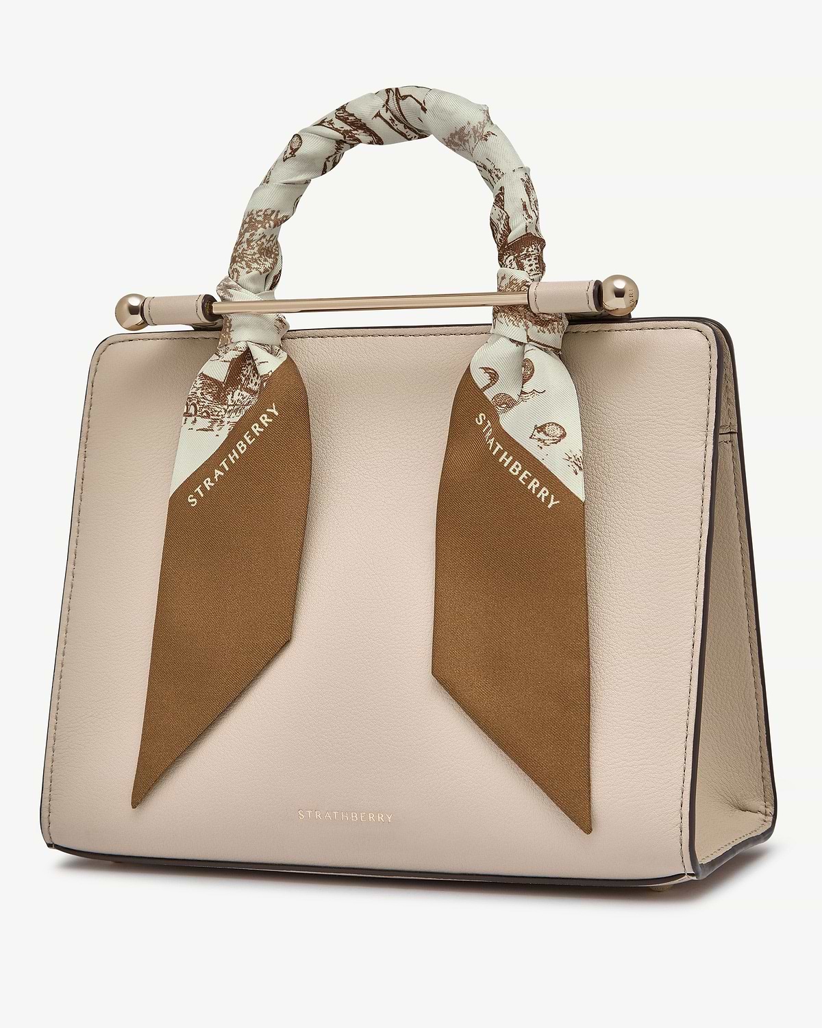 Silk skinny scarf in tan and vanilla animal print tied around beige handbag handle, Strathberry.
