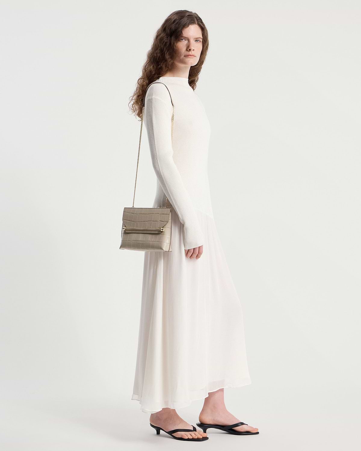 Model wearing a croc-effect Stylist bag with chain strap over shoulder