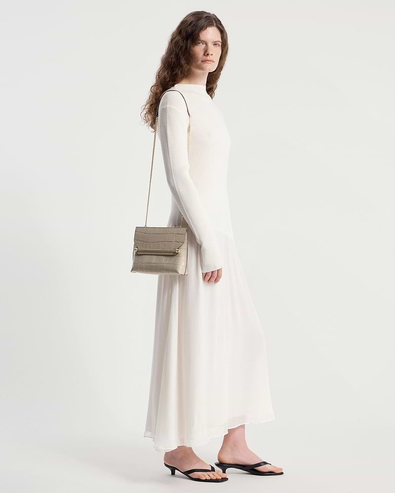Model wearing a croc-effect Stylist bag with chain strap over shoulder