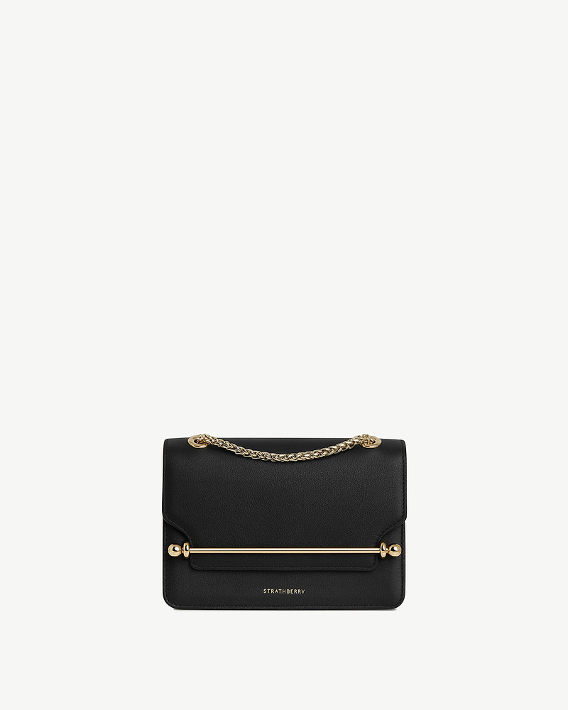 Black Strathberry East/West Mini bag with gold chain and bar detail.