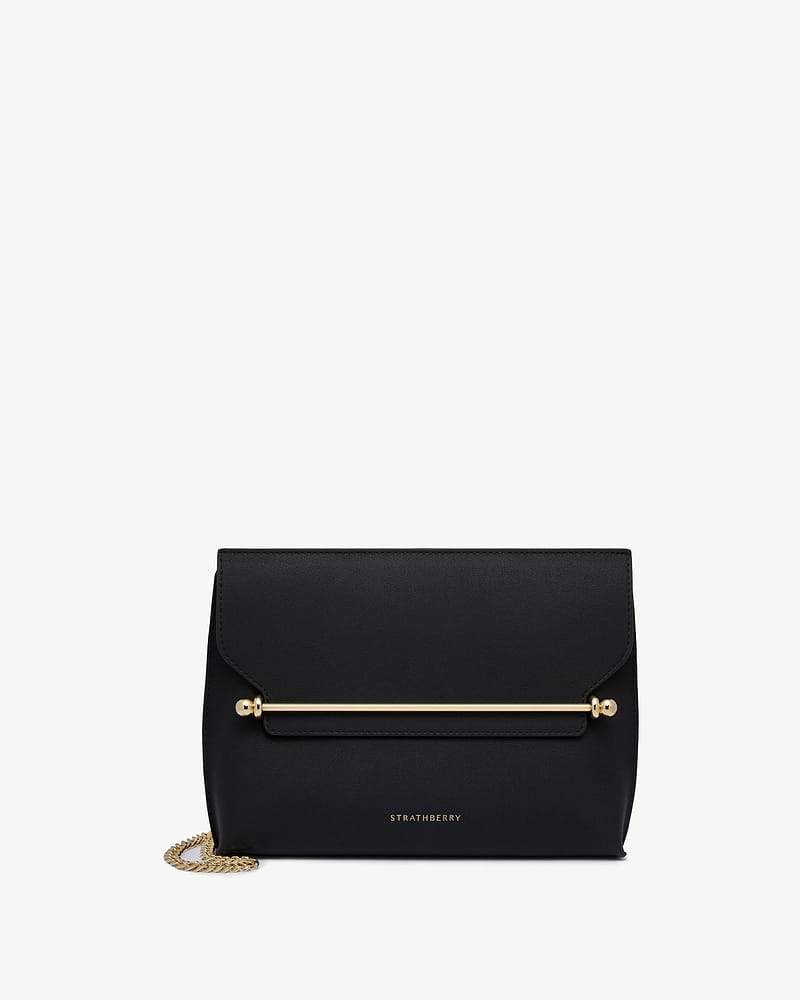 Black Strathberry Stylist leather shoulder bag with gold bar and chain.