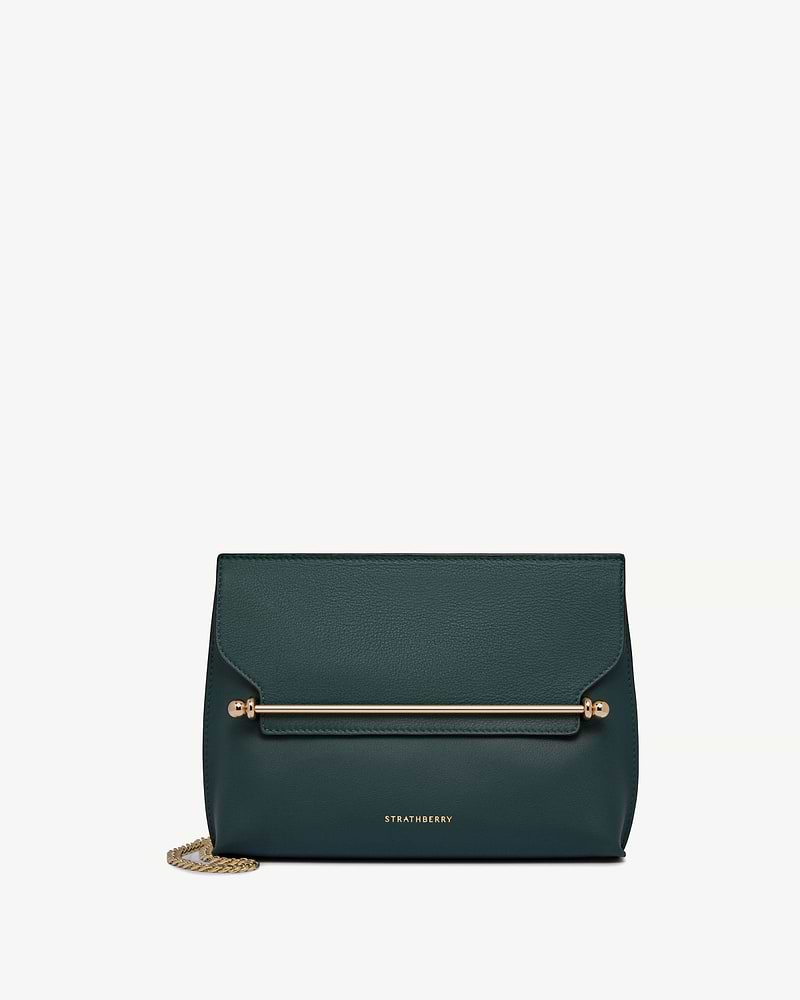 Bottle green Strathberry bag with gold bar detail and chain strap.