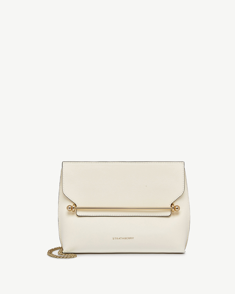 Vanilla leather stylist bag with gold bar and chain strap, Strathberry logo.