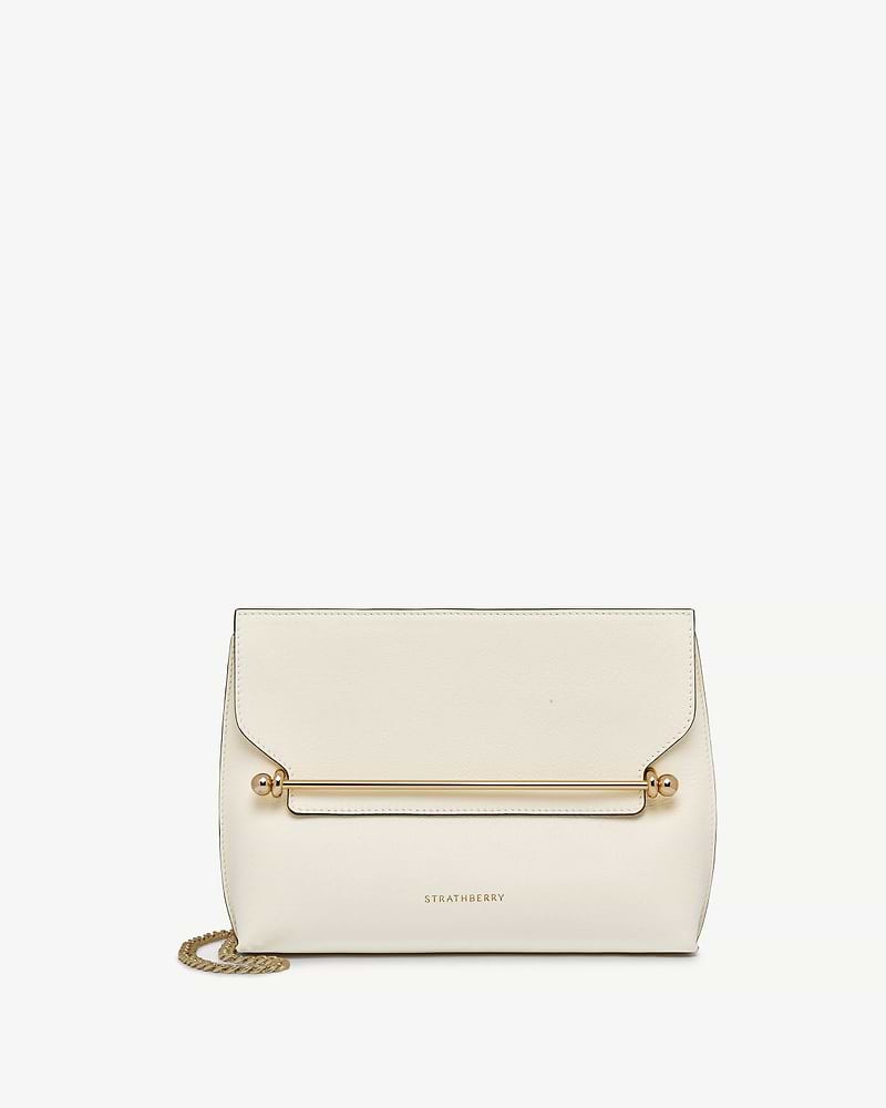 Vanilla leather stylist bag with gold bar and chain strap, Strathberry logo.