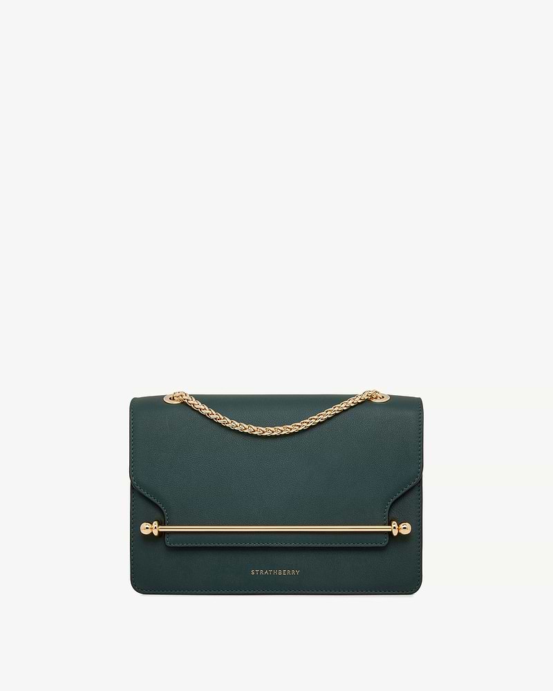 Bottle green East/West leather bag with gold chain strap, bar detail and Strathberry logo.