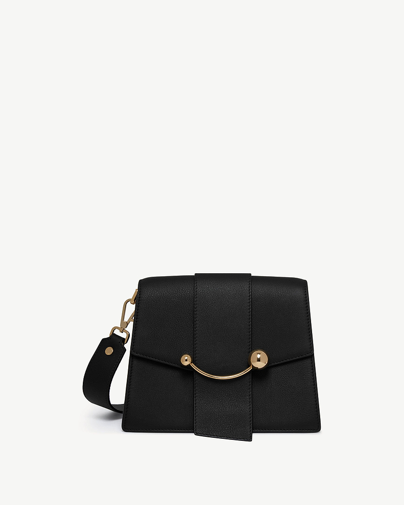 Black structured box bag with curved gold bar and detachable wide shoulder strap.