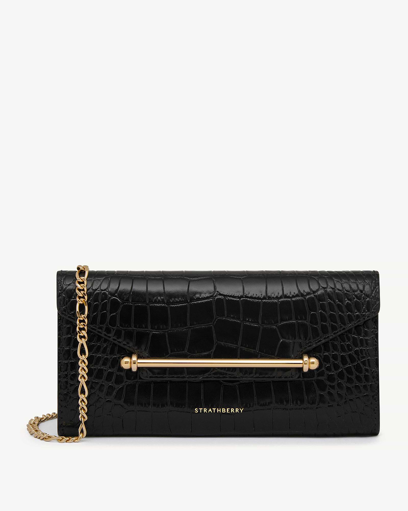 Black croc-effect Multrees chain wallet with gold bar and chain, Strathberry logo.