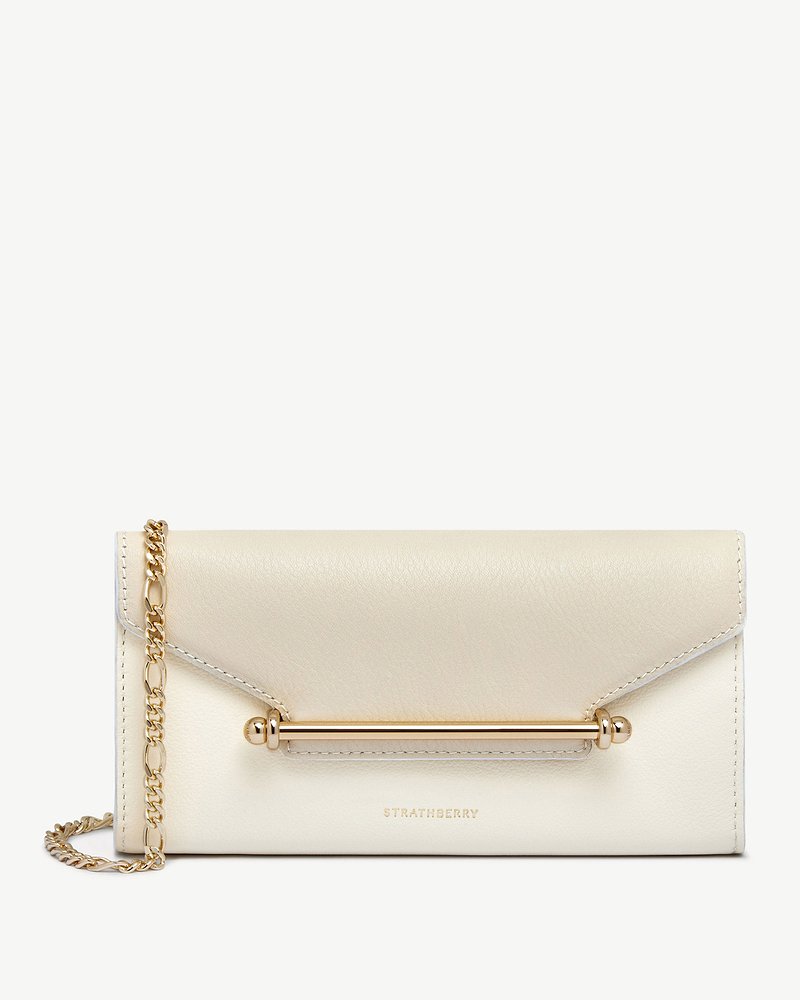 Strathberry Multrees chain wallet in vanilla and diamond leather with gold bar and chain strap.