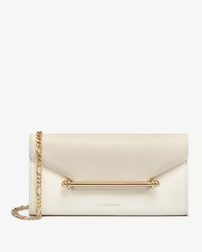 Strathberry Multrees chain wallet in vanilla and diamond leather with gold bar and chain strap.